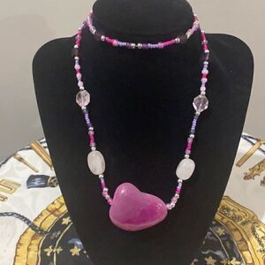 Beaded wrap necklace with heavy pink stone pendant.